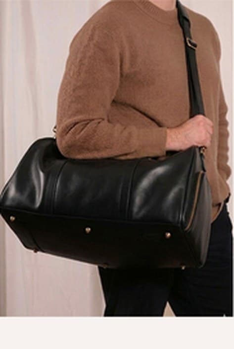 The Transformable Weekender carried as a shoulder bag